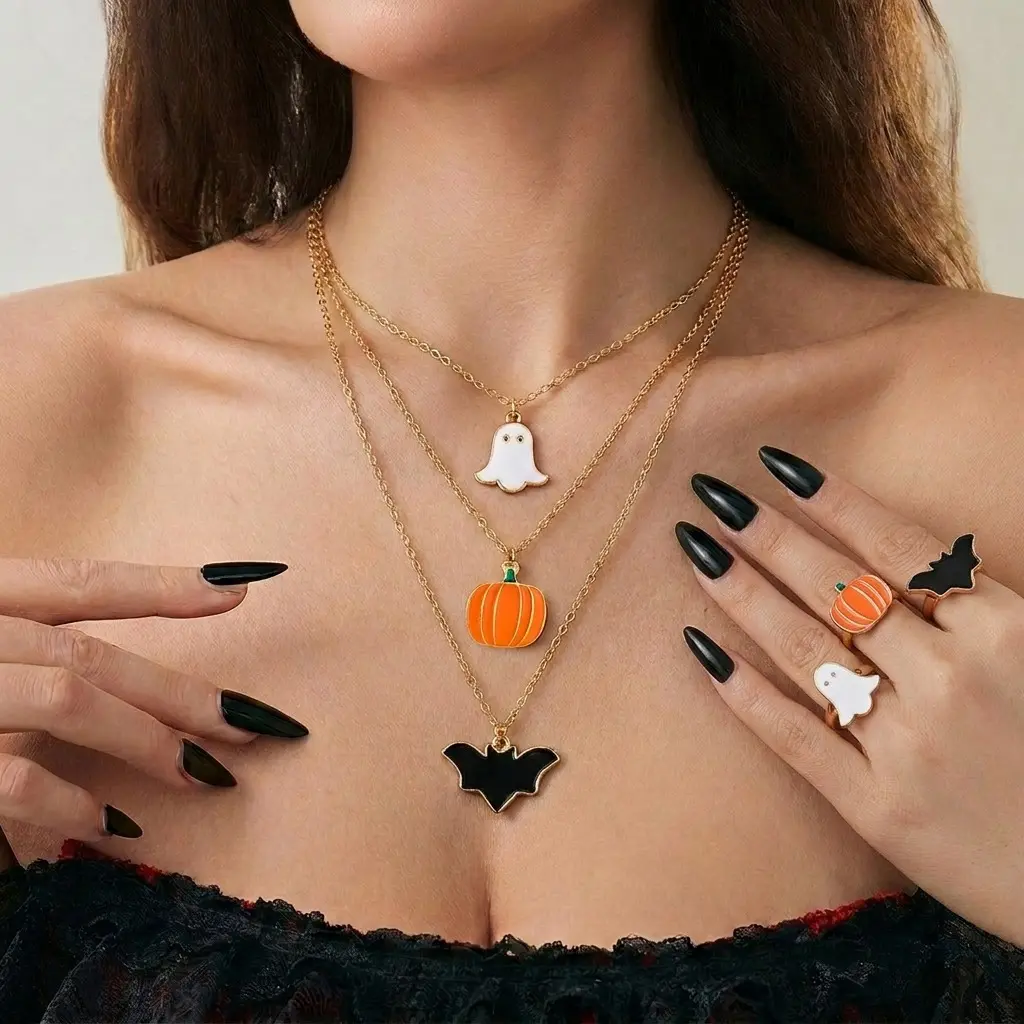 Spooky personality Halloween layered jewelry set crafted from anti-tarnish electroplated alloy. 3-tier staggered chain necklace decorated with cute enamel ghost, orange pumpkin and black bat pendants, matching coordinating ring set with identical cartoon Halloween motifs. Adjustable chain length from 41cm to 50cm, ultra-light total weight 17g for comfortable long-time party wear. Dark gothic playful vibe, ideal costume matching ornaments for Halloween parties, theme events and holiday styling for women.