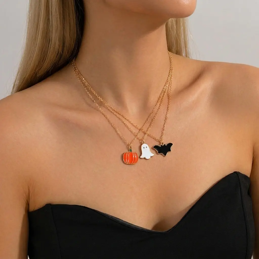 Spooky personality Halloween layered jewelry set crafted from anti-tarnish electroplated alloy. 3-tier staggered chain necklace decorated with cute enamel ghost, orange pumpkin and black bat pendants, matching coordinating ring set with identical cartoon Halloween motifs. Adjustable chain length from 41cm to 50cm, ultra-light total weight 17g for comfortable long-time party wear. Dark gothic playful vibe, ideal costume matching ornaments for Halloween parties, theme events and holiday styling for women.