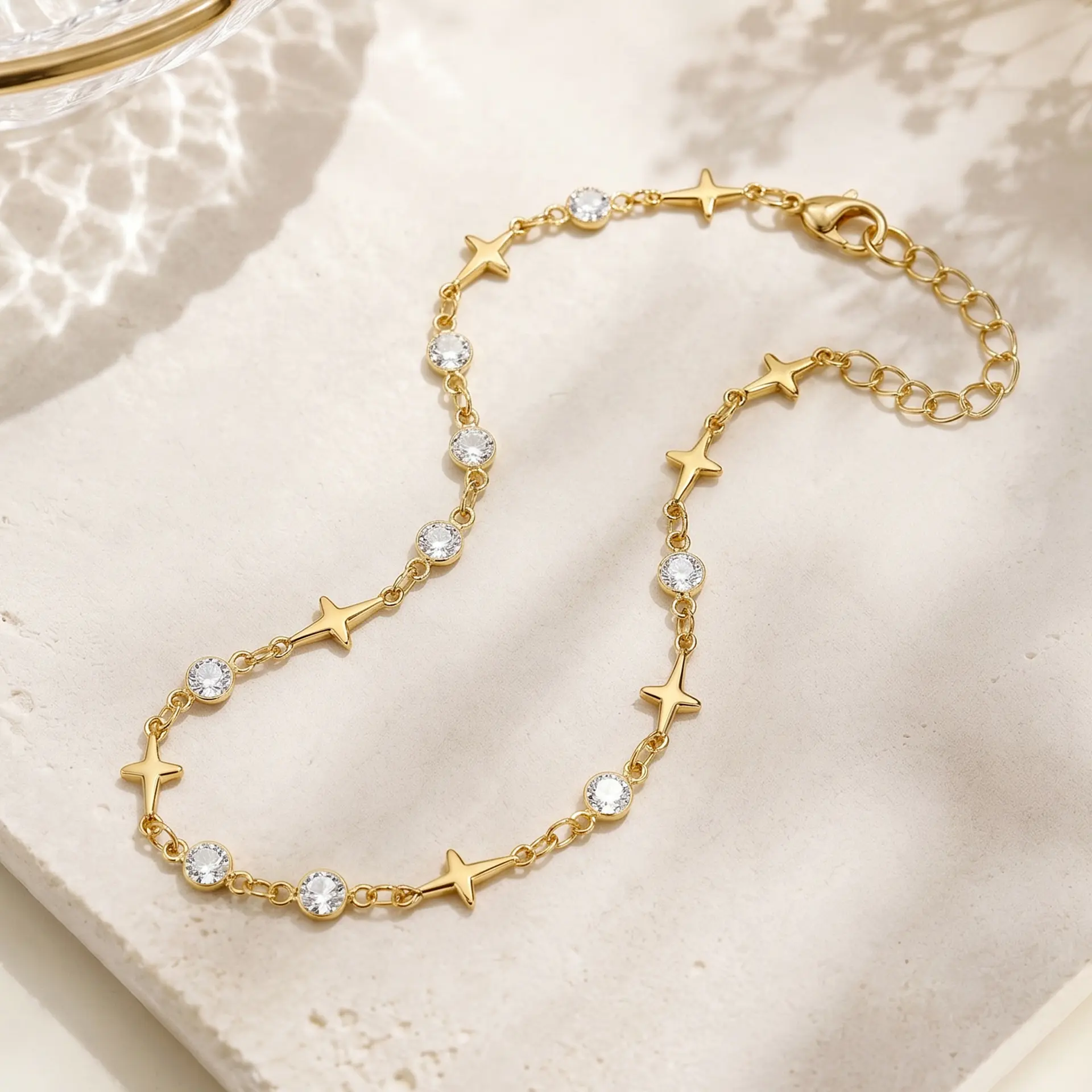 Popular minimalist European style ankle bracelet made of anti-tarnish electroplated alloy, decorated with geometric four-point star charms and round clear rhinestones in staggered layout. Equipped with extended adjustable tail chain to fit all ankle sizes, available in gold and silver two classic metallic tones. Ultra-slim lightweight chain design perfect for stackable matching, individually packed, ideal seaside travel souvenir foot accessory for women’s beach, daily and holiday styling.