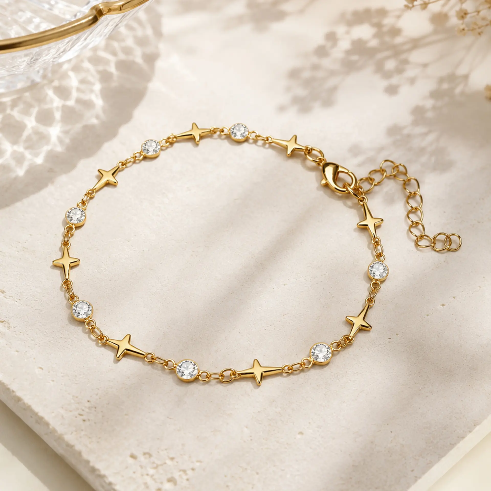 Popular minimalist European style ankle bracelet made of anti-tarnish electroplated alloy, decorated with geometric four-point star charms and round clear rhinestones in staggered layout. Equipped with extended adjustable tail chain to fit all ankle sizes, available in gold and silver two classic metallic tones. Ultra-slim lightweight chain design perfect for stackable matching, individually packed, ideal seaside travel souvenir foot accessory for women’s beach, daily and holiday styling.